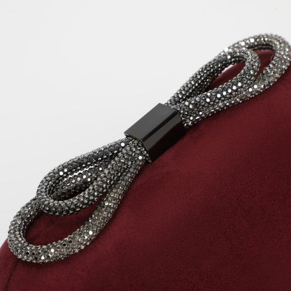 BORSA CLUTCH EFFETTO CAMOSCIO CON CHIUSURA A FIOCCO