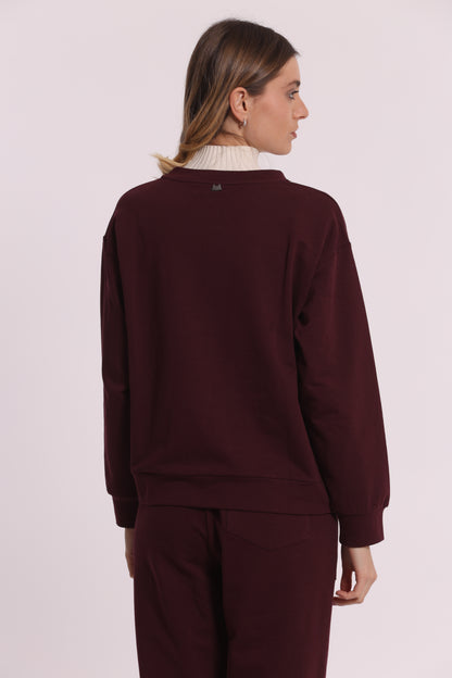 FELPA CON DETTAGLI TRAFORATI E STRASS